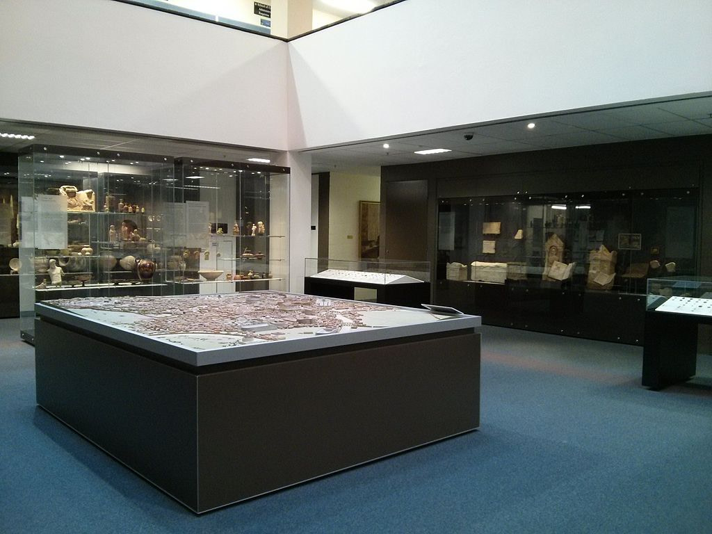 The interior of the ANU Classics Museum, with a model of ancient Rome in the foreground and some of the cases housing items in the background